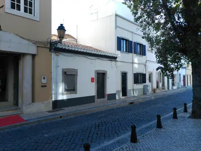 a cobblestone street in a city with white buildings at The Sunny Cottage by Freetimealgarve in Faro