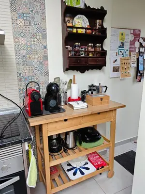 a table in a kitchen next to a stove at The Sunny Cottage by Freetimealgarve in Faro