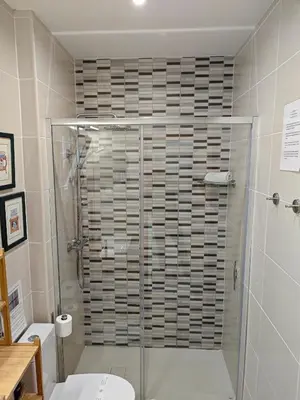 a bathroom with a shower and a toilet at The Sunny Cottage by Freetimealgarve in Faro
