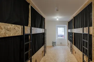 a row of lockers in a room with a window at Hostel Conii & Suites Algarve in Quarteira