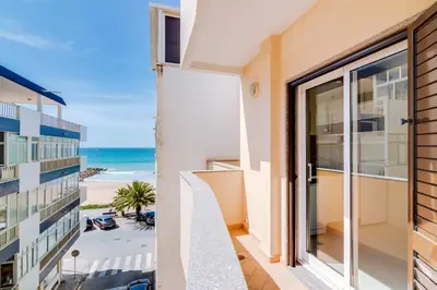 a view of the beach from the balcony of a building at AL- Apartamentos Novos Vista Mar in Quarteira