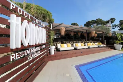a mirror leaning against a wall next to a pool at Apartamentos Honorio - Pool and Garden in Vilamoura