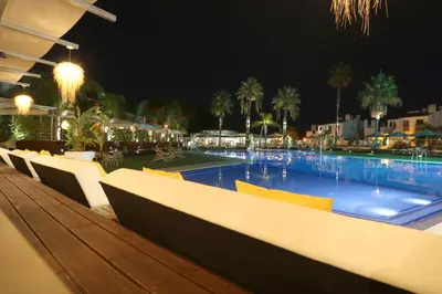 a table with four plates of food on it at Apartamentos Honorio - Pool and Garden in Vilamoura