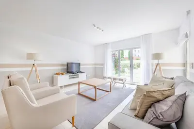 a white living room with a couch and a table at Laguna - Vilamoura in Vilamoura