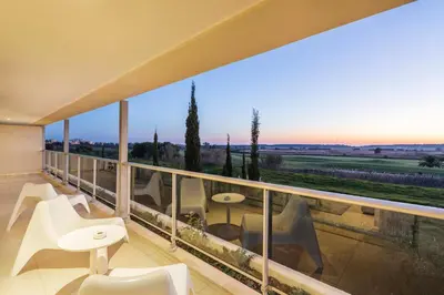 a balcony with white furniture and a view of the countryside at Laguna - Vilamoura in Vilamoura