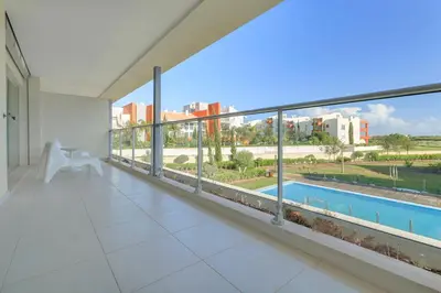 a balcony with a view of a pool and buildings at Laguna - Vilamoura in Vilamoura