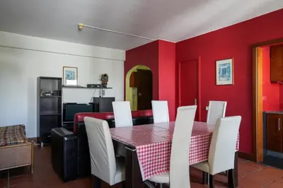 a dining room with a table and white chairs at Akisol Vilamoura Star II in Quarteira