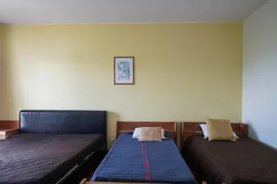 a room with two beds and a picture on the wall at Akisol Vilamoura Star II in Quarteira