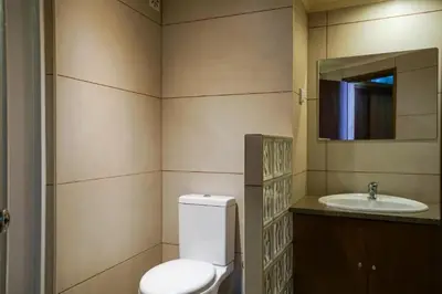 a bathroom with a toilet and a sink at Akisol Vilamoura Star II in Quarteira
