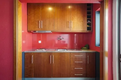 a kitchen with wooden cabinets and a sink at Akisol Vilamoura Star II in Quarteira