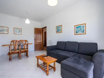 a living room with a couch and a table at Akisol Quarteira Relax III in Quarteira
