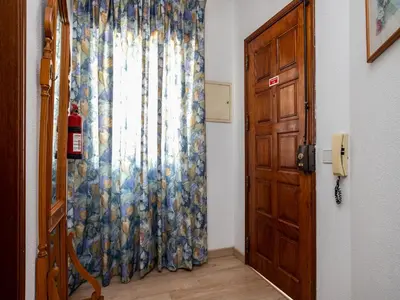 a door with a curtain next to a window at Akisol Quarteira Relax III in Quarteira