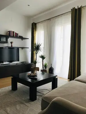 a living room with a tv and a coffee table at MariaHouse in Faro