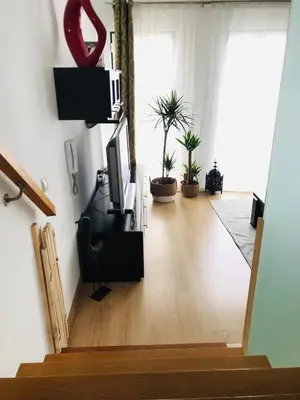 a room with a staircase with a television and plants at MariaHouse in Faro