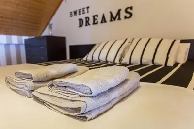 three towels sitting on top of a bed at MariaHouse in Faro