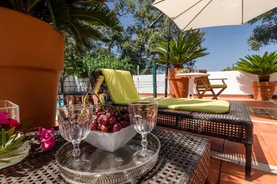 a table with glasses and a bowl of fruit on a patio at Villa Casa do Sul in Albufeira