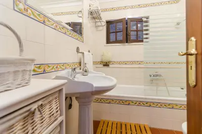 a bathroom with a sink and a tub at Villa Casa do Sul in Albufeira