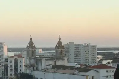 a building with two towers in a city with buildings at BellaVita City Faro in Faro