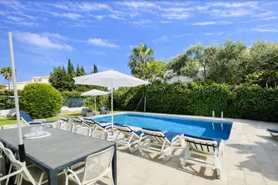 a patio with a table and chairs and a pool at Strip by Check-in Portugal in Albufeira