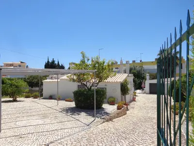 a courtyard of a house with a fence at Strip by Check-in Portugal in Albufeira