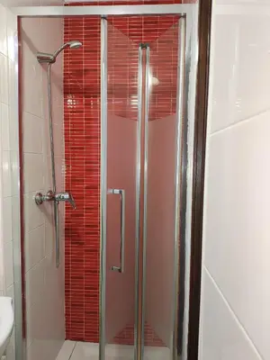 a shower with a glass door in a bathroom at Casa Azul in Albufeira