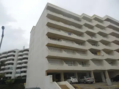 a white building with cars parked in front of it at Moura 11 in Vilamoura
