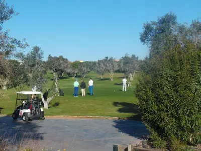 a group of people playing golf in a park at Moura 11 in Vilamoura