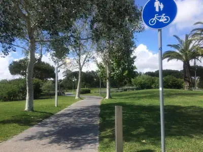 a sign for a bike path in a park at Moura 11 in Vilamoura