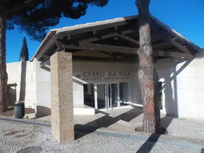 a building with a sign for the greco da vitale center at Moura 11 in Vilamoura