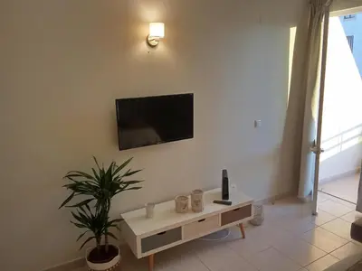 a living room with a tv on a wall at Moura 11 in Vilamoura