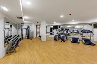 a gym with several treadmills and elliptical machines at Vilamoura Garden Hotel in Vilamoura