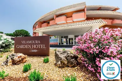 a hotel with flowers in front of a building at Vilamoura Garden Hotel in Vilamoura
