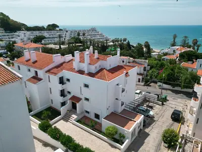 a white building with a view of the ocean at Cheerfulway Ouravista Apartamentos in Albufeira