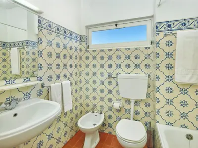 a blue and white bathroom with a toilet and a sink at Cheerfulway Ouravista Apartamentos in Albufeira