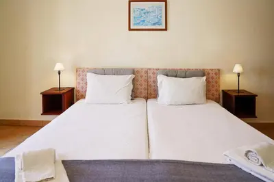 a bedroom with a large bed with two white pillows at Cheerfulway Ouravista Apartamentos in Albufeira