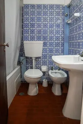 a bathroom with a white toilet and a sink at Cheerfulway Ouravista Apartamentos in Albufeira