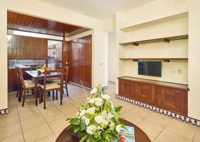 a living room with a table and a dining room at Cheerfulway Ouravista Apartamentos in Albufeira