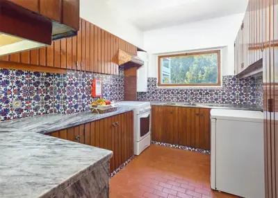 a large kitchen with wooden cabinets and a window at Cheerfulway Ouravista Apartamentos in Albufeira