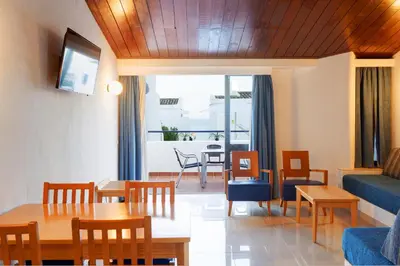 a living room with a table and chairs and a couch at 3HB Golden Beach in Albufeira