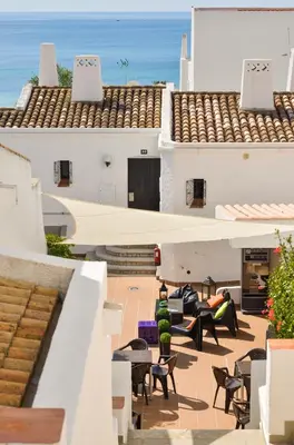 a view from the balcony of a house with chairs and tables at 3HB Golden Beach in Albufeira