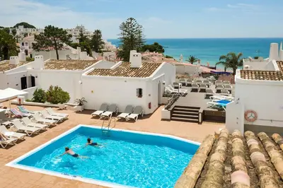two people in a swimming pool at a resort at 3HB Golden Beach in Albufeira