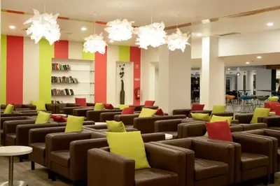 a living room and kitchen with a table and a couch at Luna Miramar Club in Albufeira
