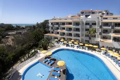 a swing on a beach near the ocean at Luna Miramar Club in Albufeira