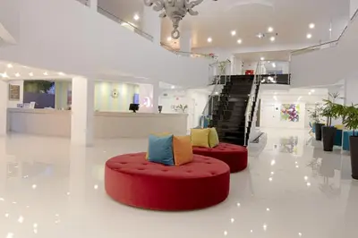 a waiting room with brown chairs and colorful pillows at Luna Miramar Club in Albufeira