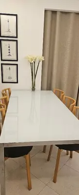 a white table with a vase of flowers on it at Golf & Mar - T2 Apartment in Vilamoura