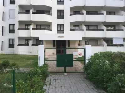 an apartment building with a gate in front of it at Golf & Mar - T2 Apartment in Vilamoura