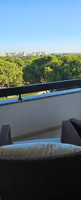 a balcony with a bed and a view of a city at Golf & Mar - T2 Apartment in Vilamoura