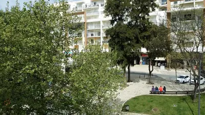 a group of people standing in a park in front of a building at Studio near the beach in Albufeira