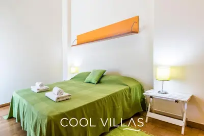 a bedroom with a green bed with towels on it at Villa AcquaMarina - 5 bedroom, water front villa in Albufeira