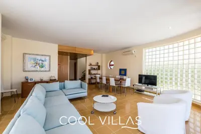a living room with a blue couch and a tv at Villa AcquaMarina - 5 bedroom, water front villa in Albufeira